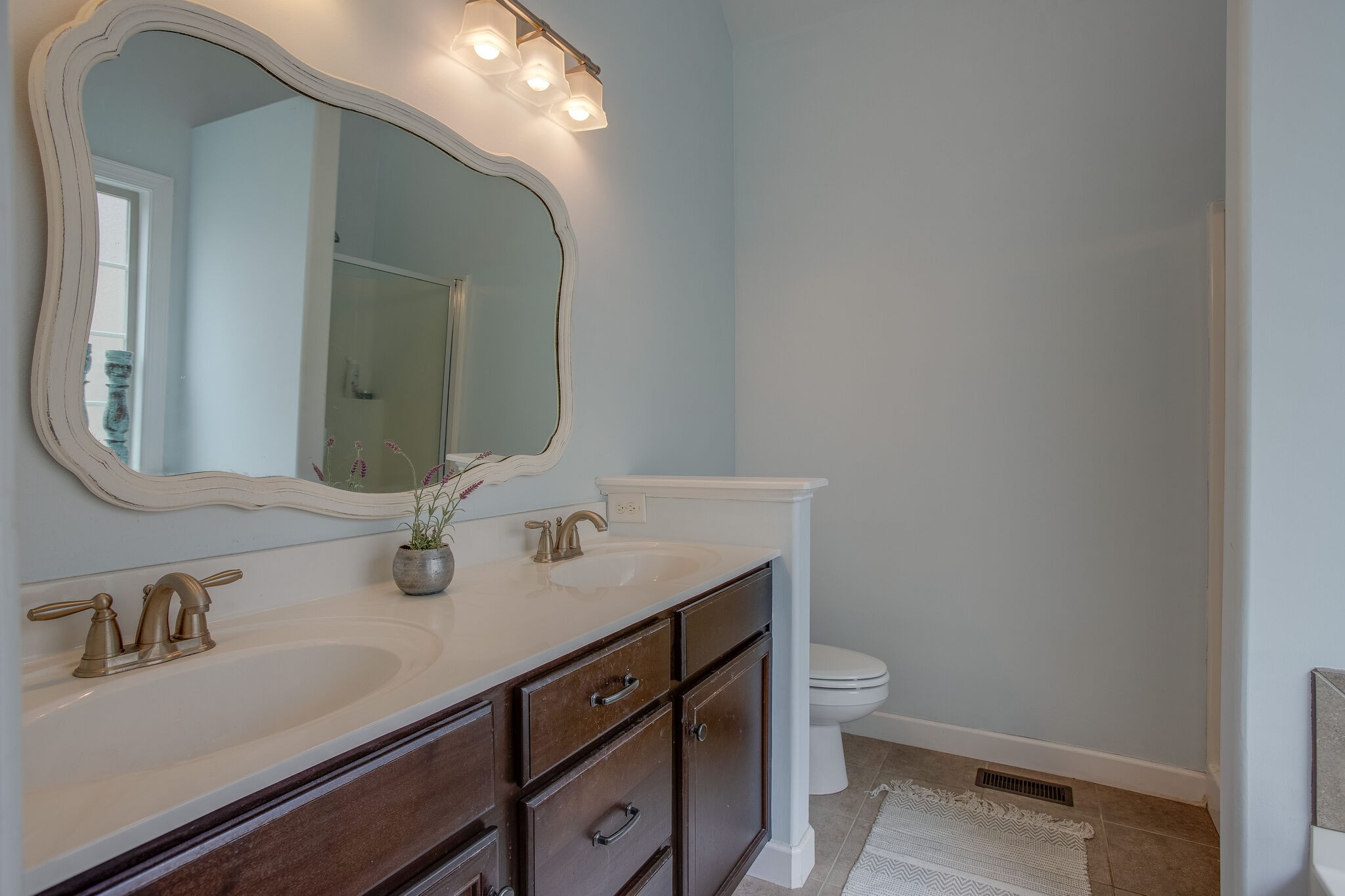 1073 Golf View Way Spring Hill, TN 37174 - Photo 21 of 34 a bathroom with a sink a toilet and a mirror