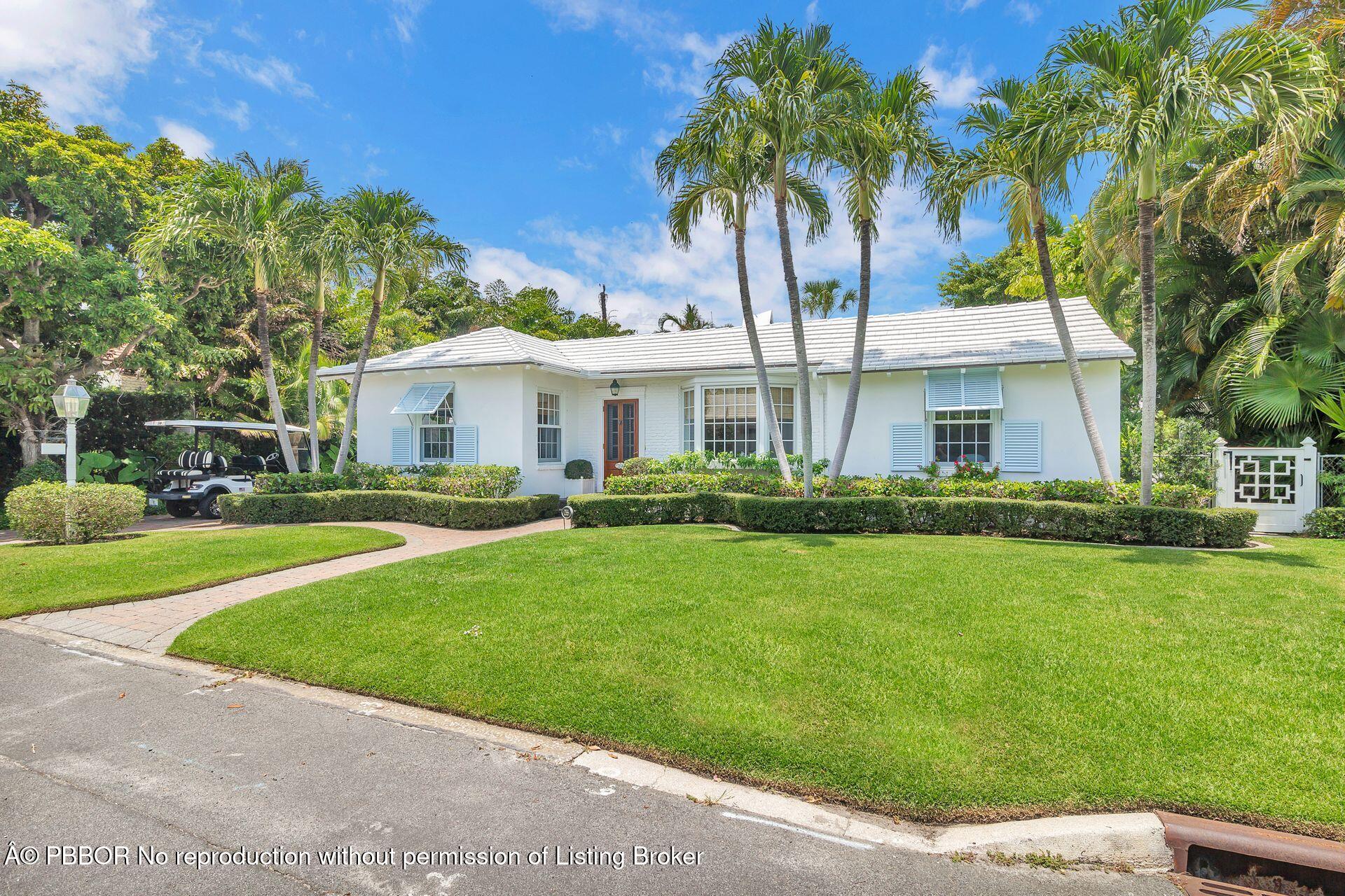 255 Colonial Lane Palm Beach, FL 33480 - Photo 1 of 32 a front view of a house with a garden and yard