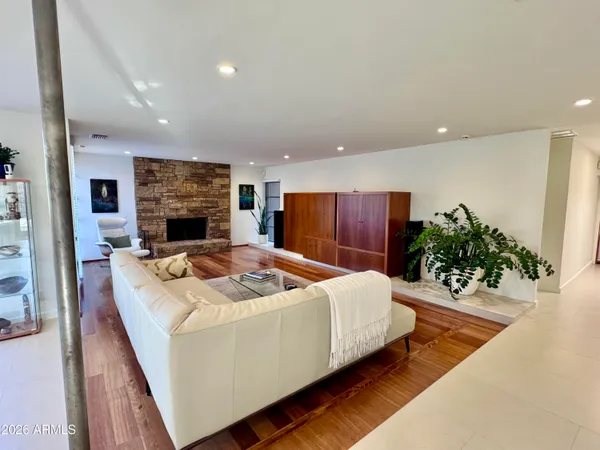 a dining room with furniture and a floor to ceiling window