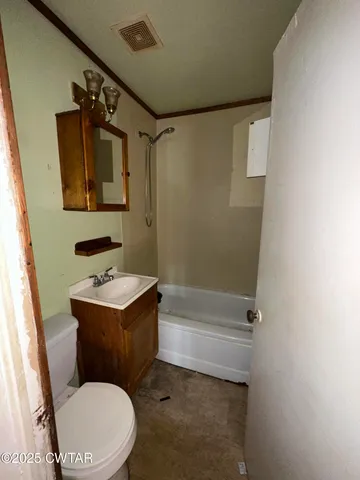 a bathroom with a toilet a sink and bathtub