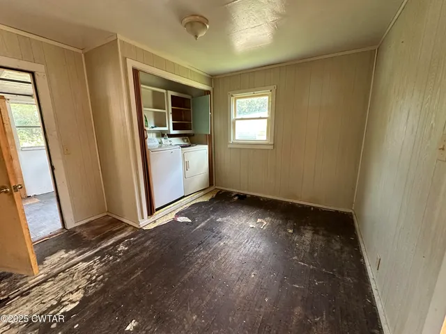 a view of a utility room with window and wooden floor