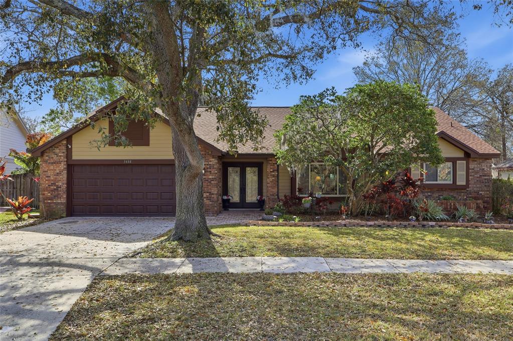 3488 Ridge Boulevard Palm Harbor, FL 34684 - Photo 1 of 30 a front view of a house with a yard and garage