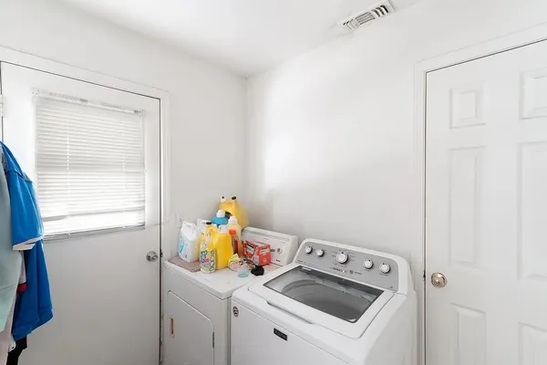 a view of storage and utility room with a window