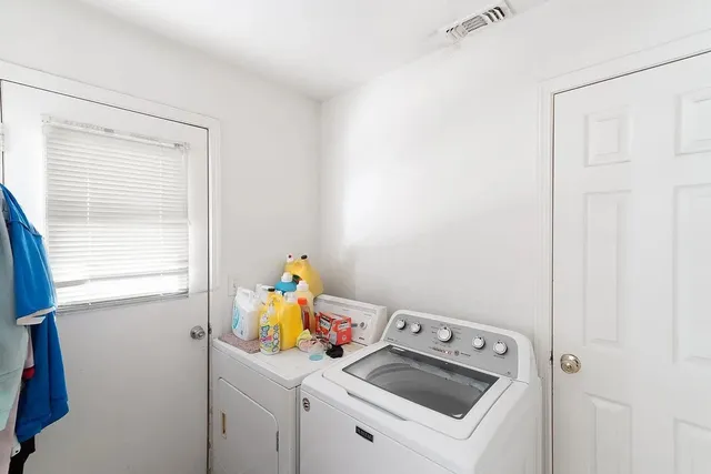 a view of storage and utility room with a window