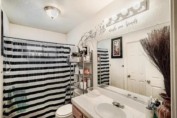 a bathroom with a sink toilet and shower