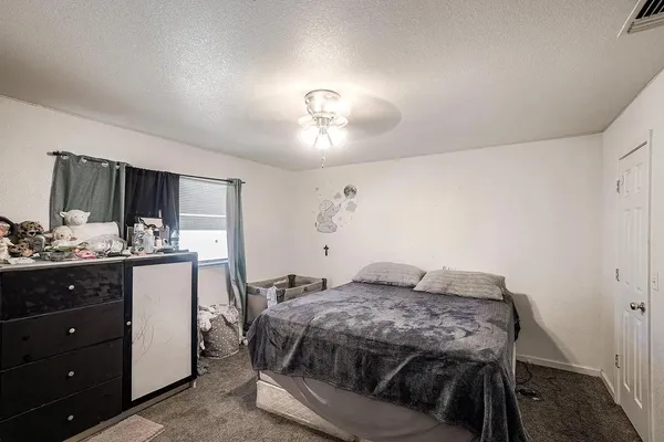 a bedroom with a bed and a dresser