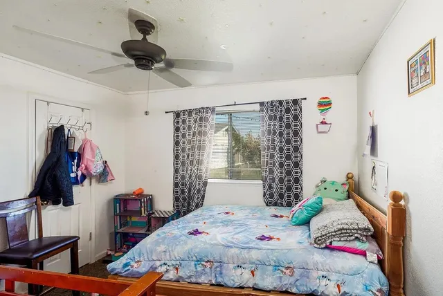 a bedroom with a bed and a window