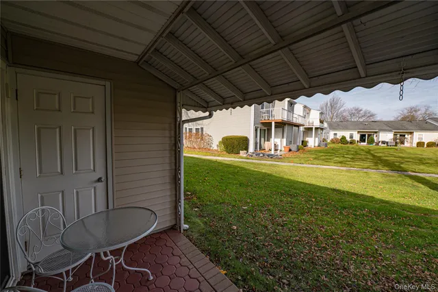 a view of a porch with furniture and a yard