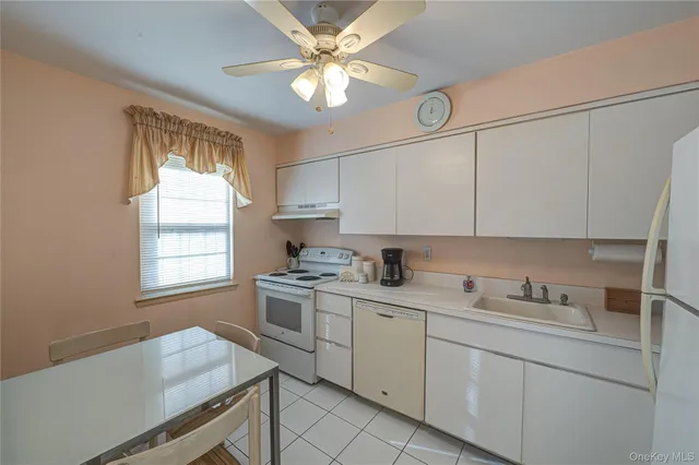 a kitchen with a sink cabinets and window