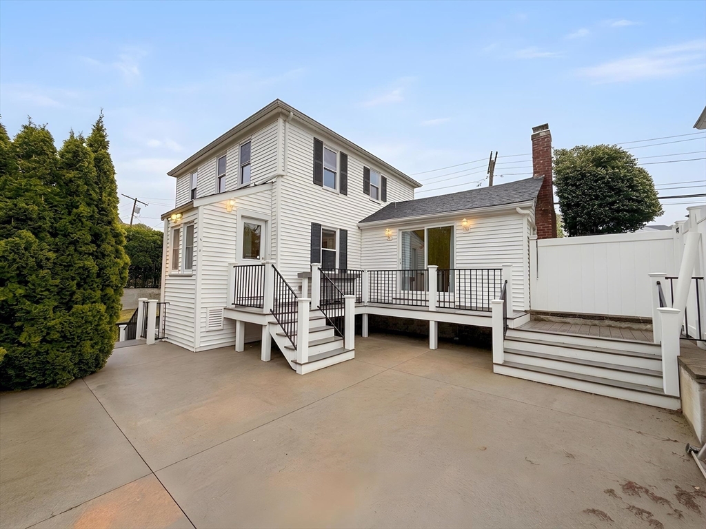 114 Curve Street Dedham, MA 02026 - Photo 24 of 27 a view of a house with a barbeque and wooden stairs