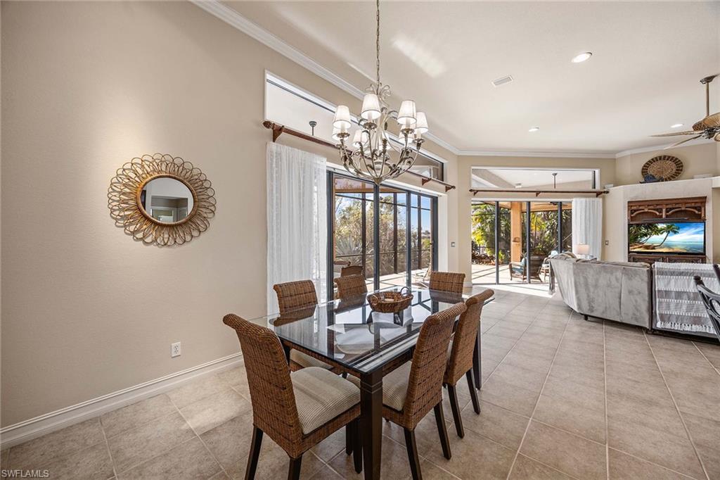 146 Windward Cay Naples, FL 34114 - Photo 13 of 33 a dining room with furniture a chandelier and window