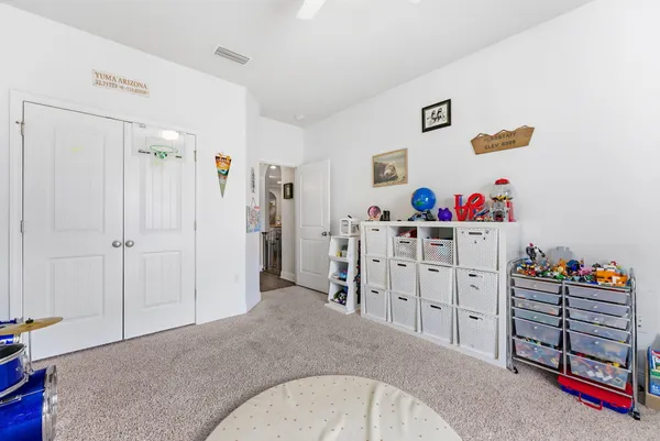 a view of a bedroom with closet and cabinet
