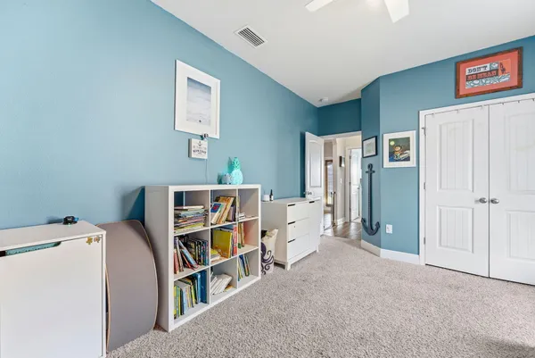 a bed room with a bed and a chandelier