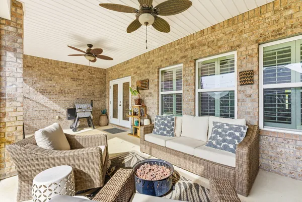 a view of a house with backyard sitting area and porch
