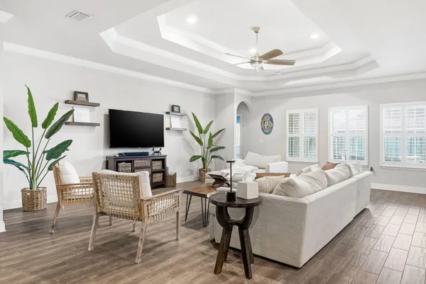 a living room with furniture a large window and a flat screen tv