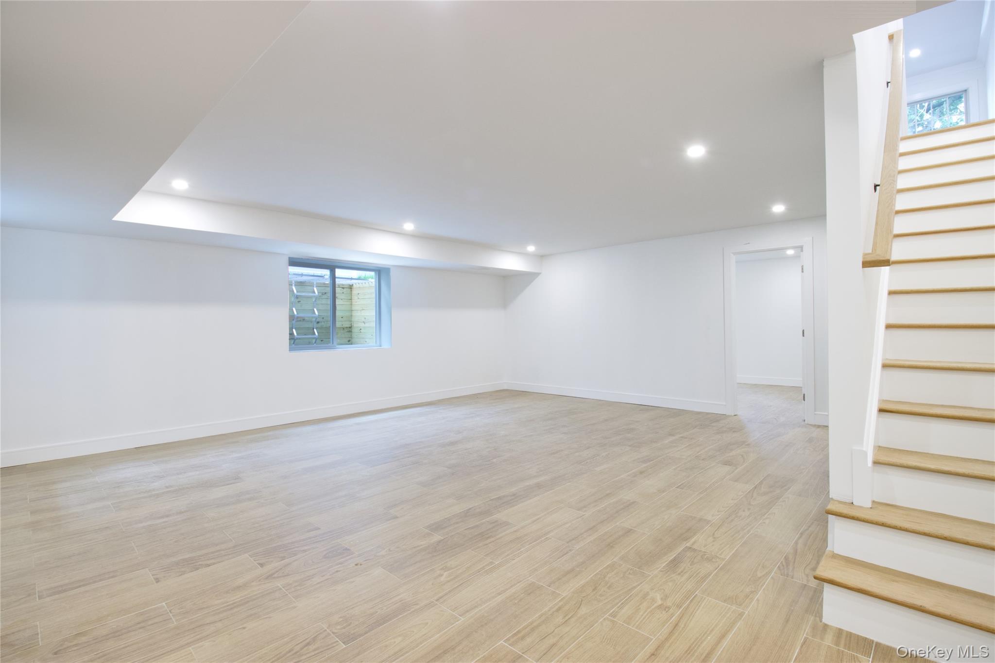 30 Kirkwood Road, Unit B Port Washington, NY 11050 - Photo 30 of 36 an empty room with wooden floor and windows