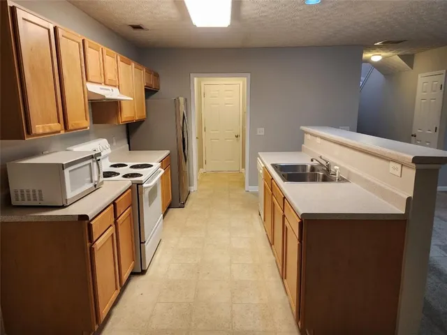 a kitchen that has a sink and a stove
