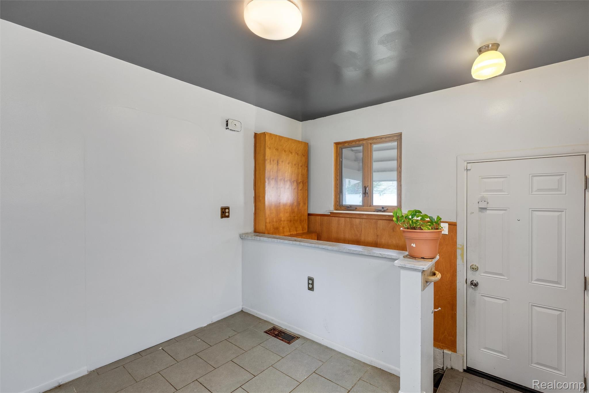9522 Pardee Road Taylor, MI 48180 - Photo 9 of 25 Tile flooring, wood-paneled accents, built-in wooden cabinet, ceiling-mounted lighting fixtures, white paneled entry door