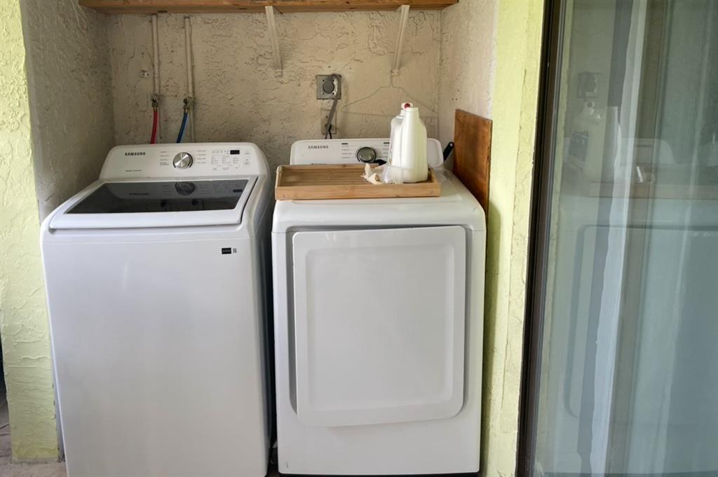 9273 Southwest 8th Street, Unit 117 Boca Raton, FL 33428 - Photo 5 of 7 a utility room with dryer and washer