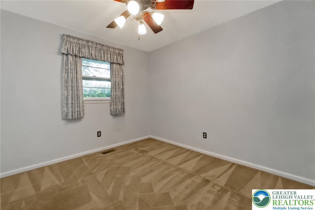 1328 Russett Road Allentown, PA 18104 - Photo 22 of 46 A comfortable private bedroom offering a tranquil retreat with soft carpet and a refreshing ceiling fan.