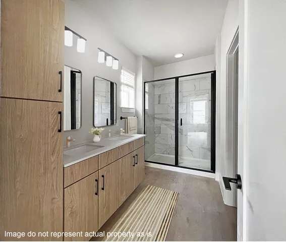 a bathroom with a double vanity sink and mirror