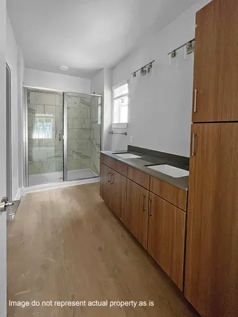 a view of a kitchen with a sink and cabinets