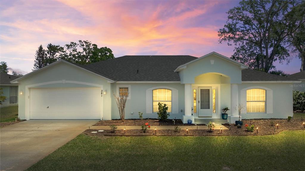 a front view of a house with a garden