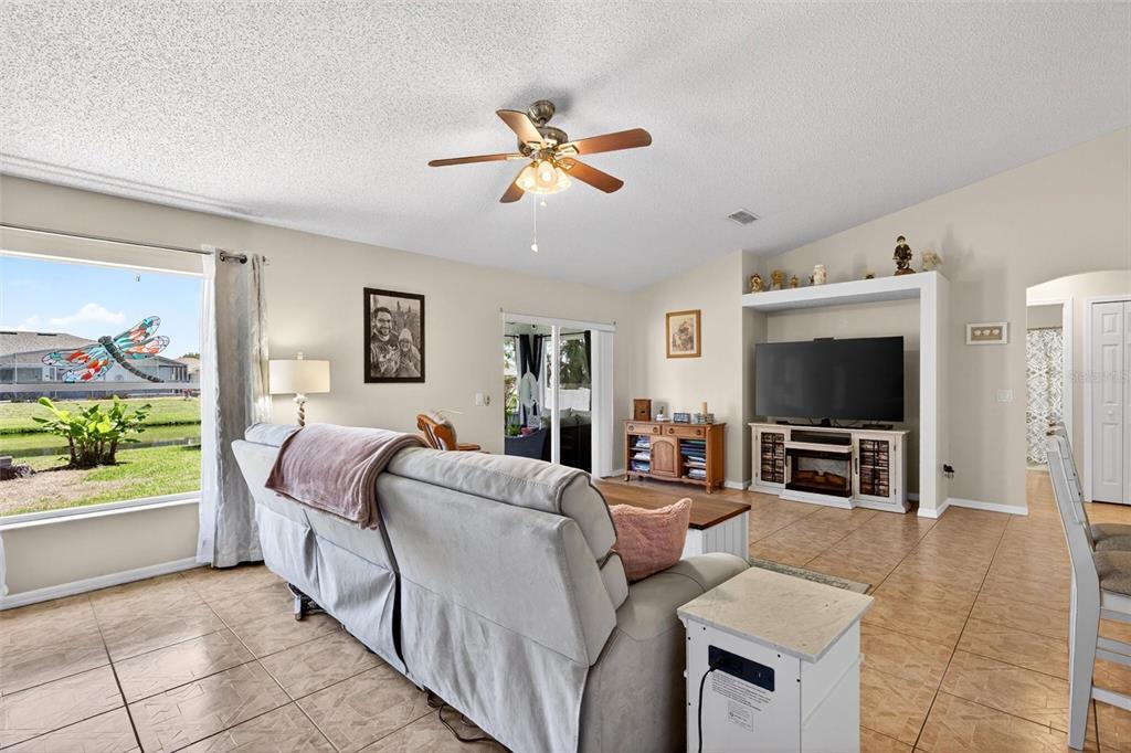 341 Mariners Gate Drive Edgewater, FL 32141 - Photo 13 of 53 a living room with furniture and a flat screen tv