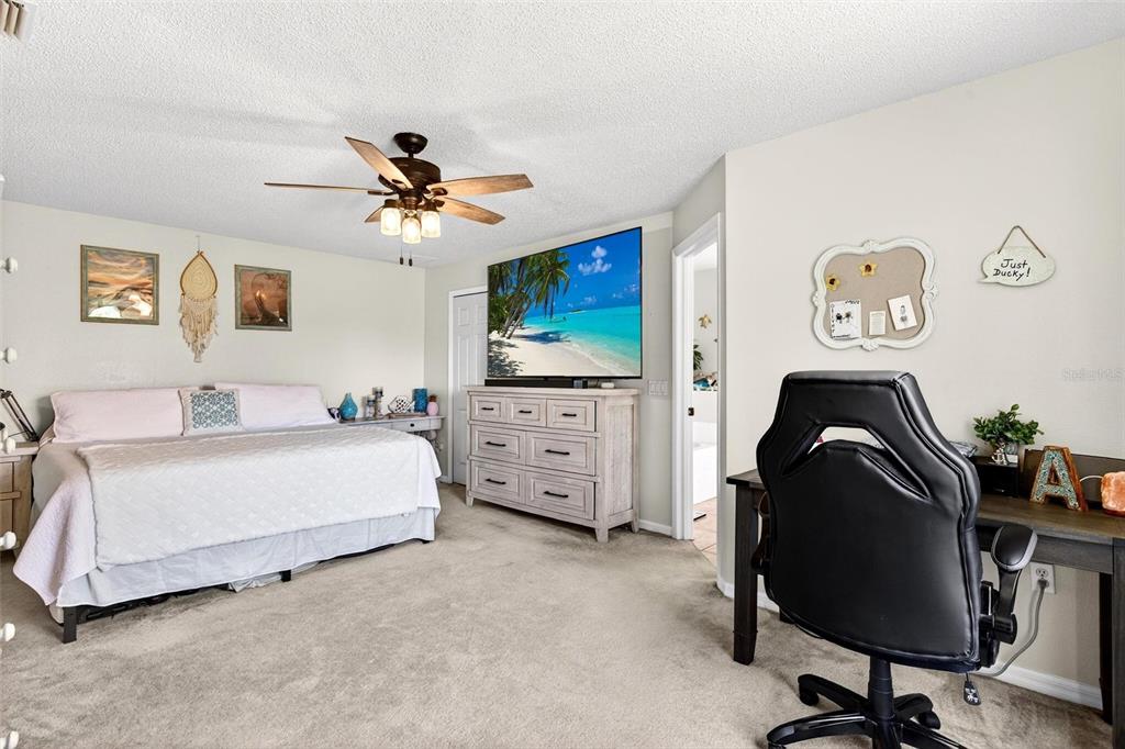 341 Mariners Gate Drive Edgewater, FL 32141 - Photo 20 of 53 a bedroom with a bed and a chandelier