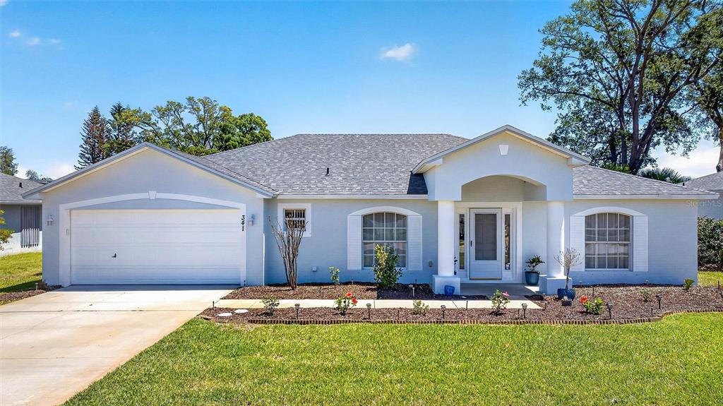 341 Mariners Gate Drive Edgewater, FL 32141 - Photo 2 of 53 a front view of a house with a yard and garage
