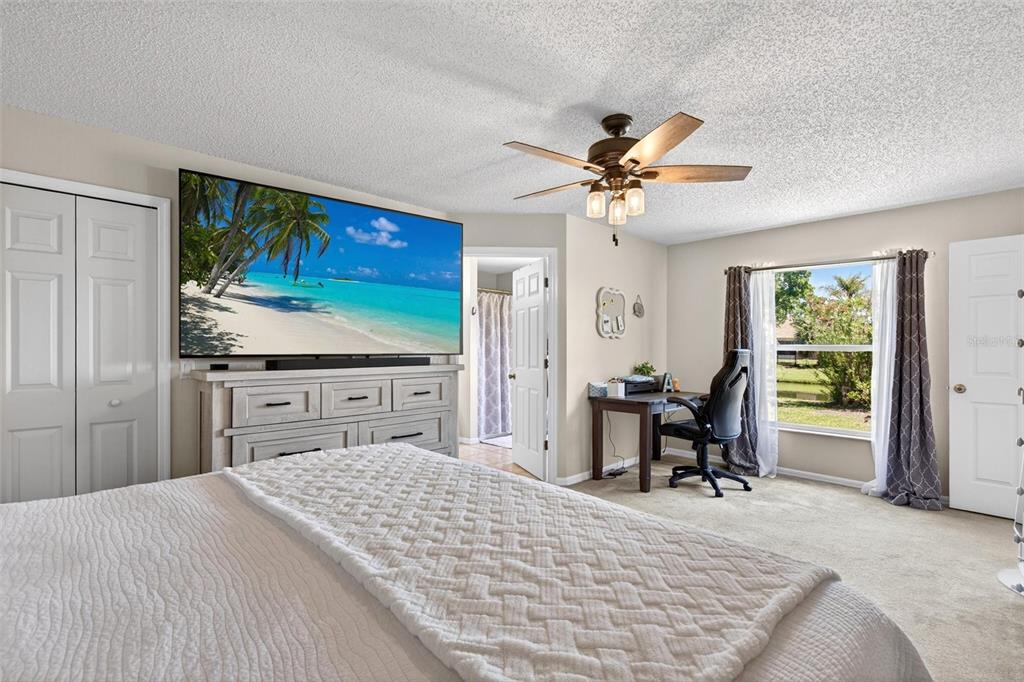 341 Mariners Gate Drive Edgewater, FL 32141 - Photo 21 of 53 a bedroom with a bed and a chair with the outer view