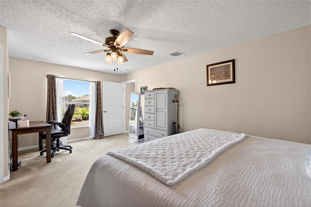 341 Mariners Gate Drive Edgewater, FL 32141 - Photo 22 of 53 a bedroom with a bed and a chandelier