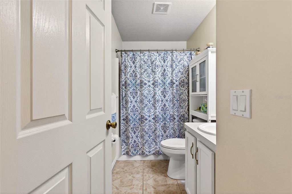 341 Mariners Gate Drive Edgewater, FL 32141 - Photo 29 of 53 a bathroom with a toilet and shower curtain