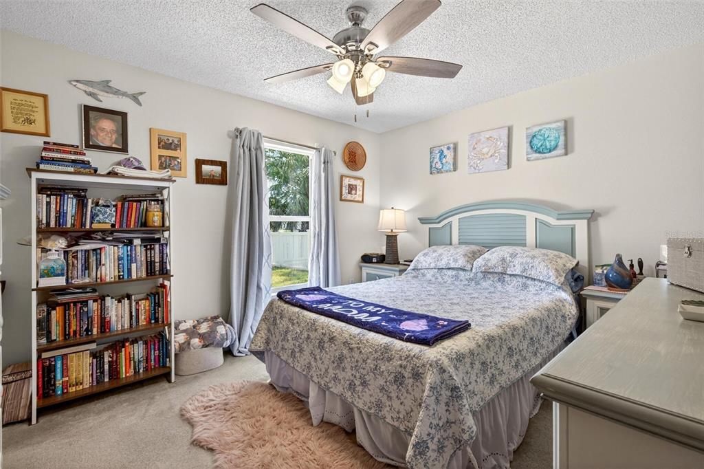 341 Mariners Gate Drive Edgewater, FL 32141 - Photo 31 of 53 a bedroom with a bed a book shelf and a book shelf