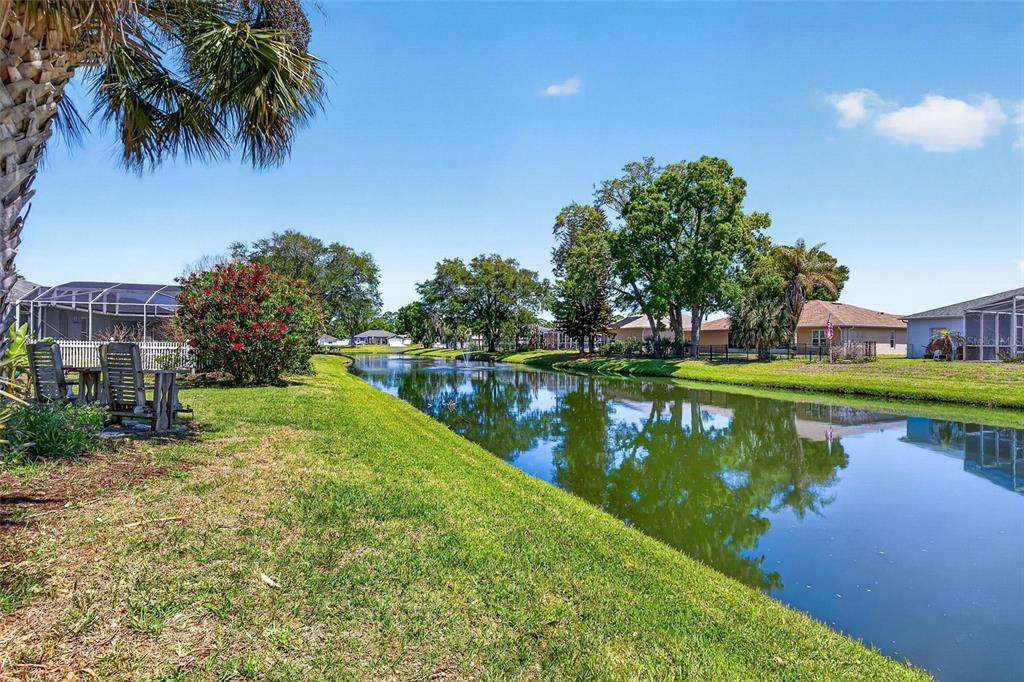 341 Mariners Gate Drive Edgewater, FL 32141 - Photo 45 of 53 a view of a lake with a building in the background