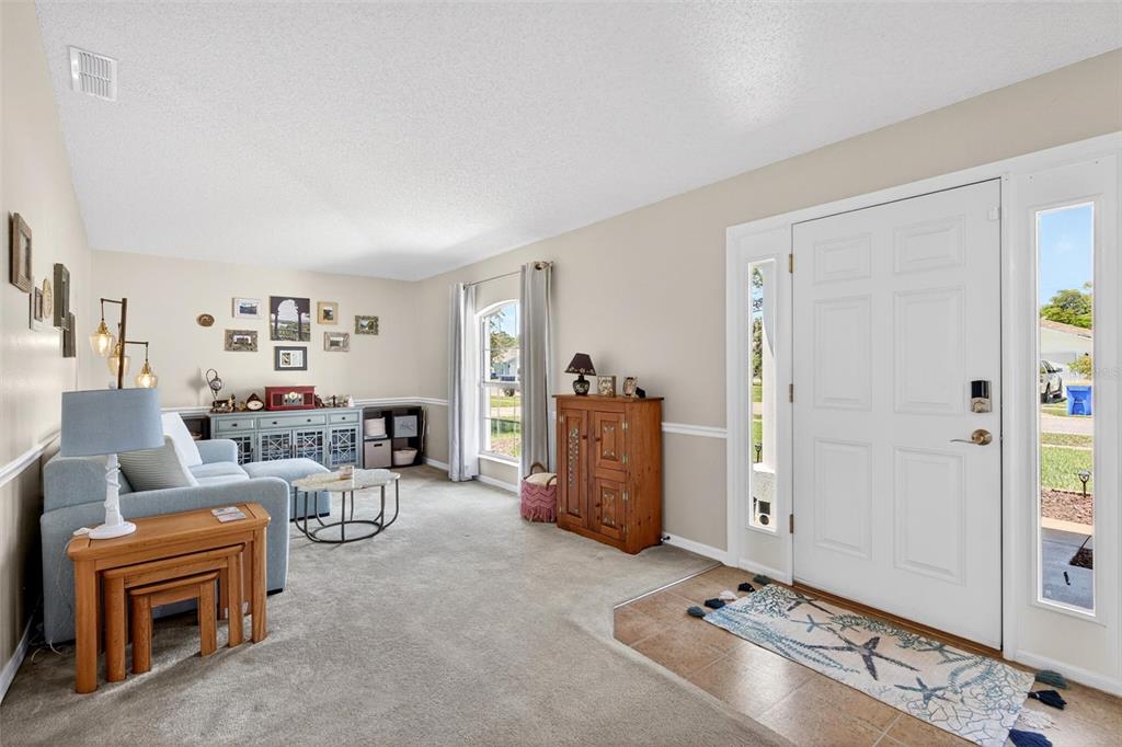 341 Mariners Gate Drive Edgewater, FL 32141 - Photo 5 of 53 a living room with furniture a window and gym equipment