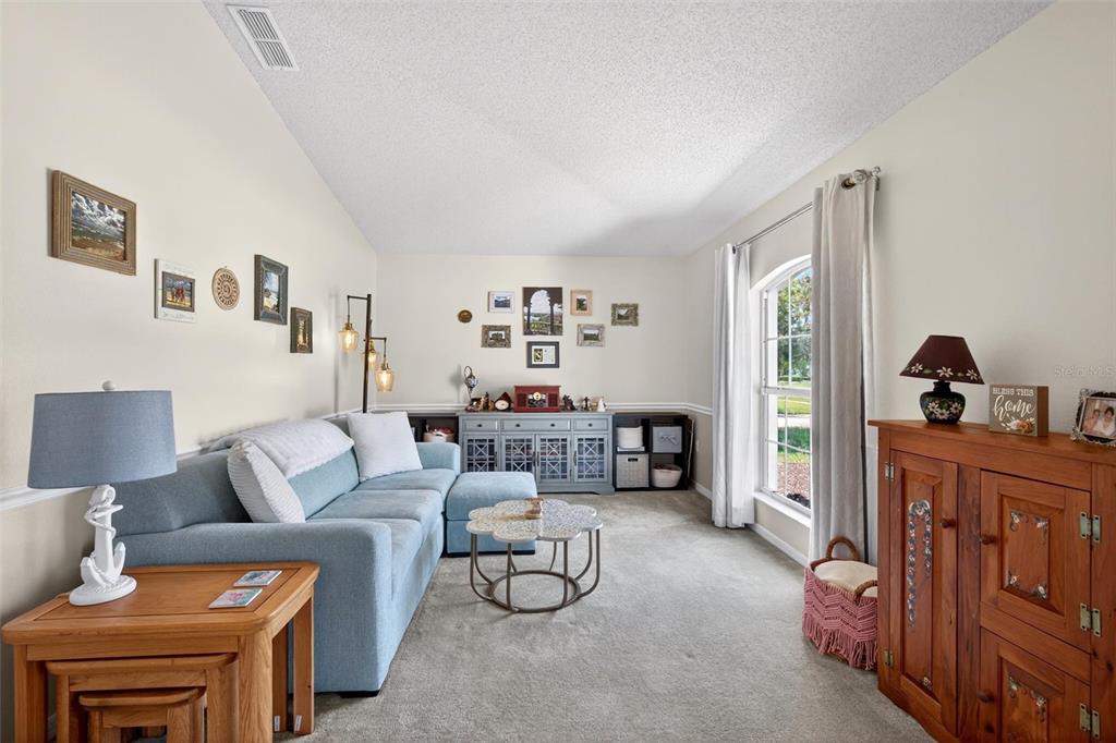 341 Mariners Gate Drive Edgewater, FL 32141 - Photo 6 of 53 a living room with furniture and a window