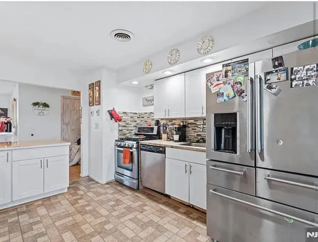 a kitchen with a refrigerator and cabinets
