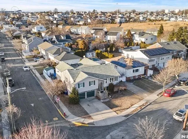 an aerial view of residential houses with outdoor space