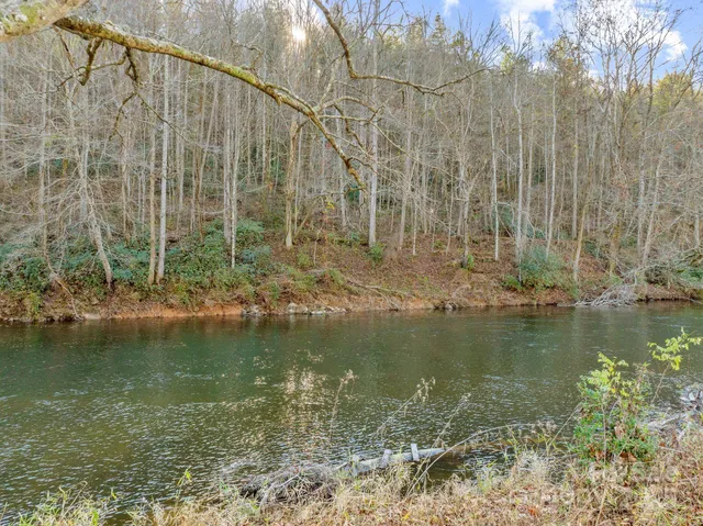 a kitchen that has a lot of cabinets and wooden floor