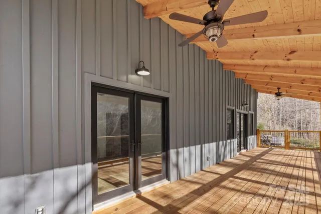 a view of swimming pool with a yard and large trees