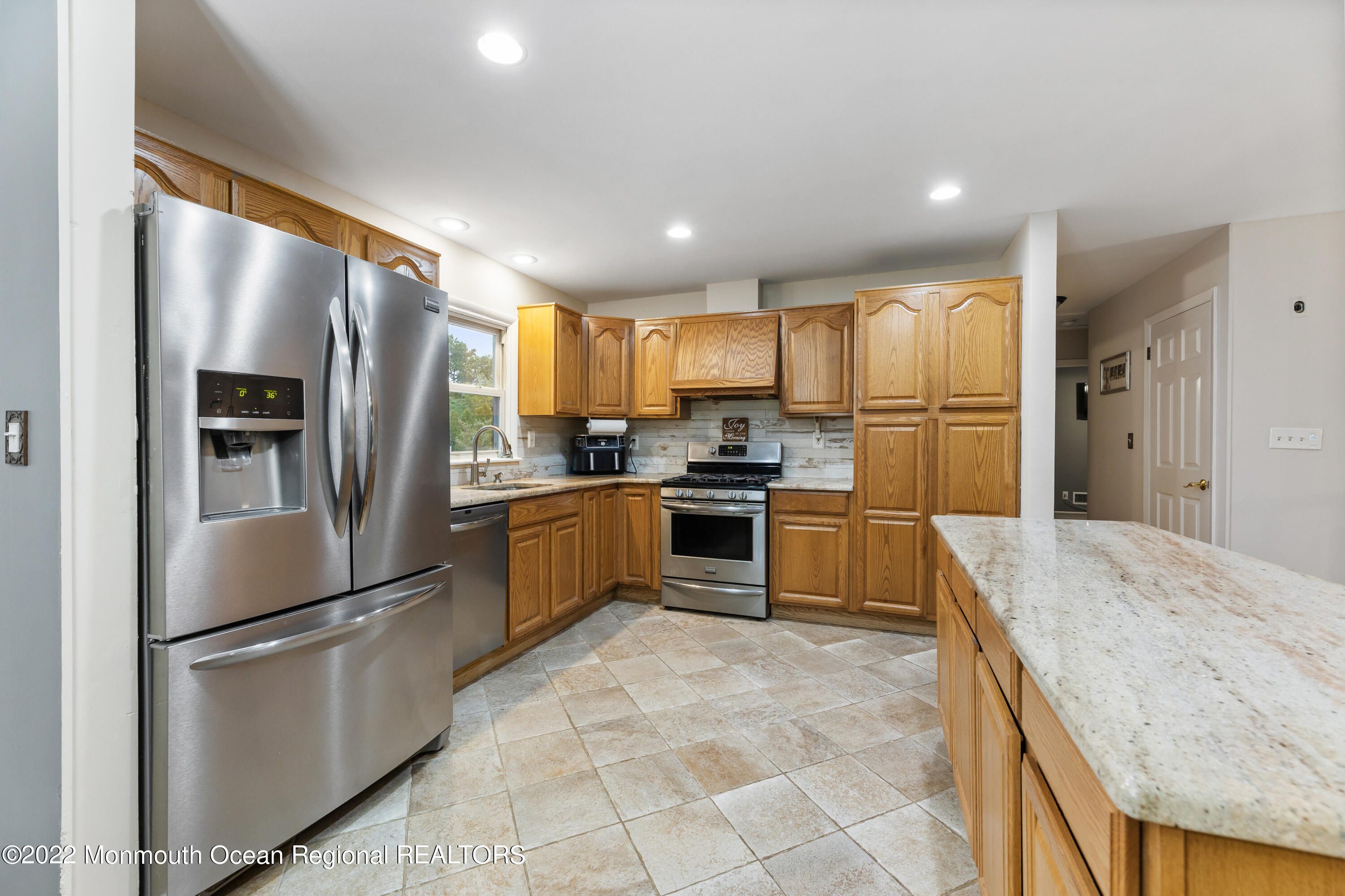 21 Holiday Road Manalapan, NJ 07726 - Photo 15 of 30 a kitchen with granite countertop a refrigerator and a sink