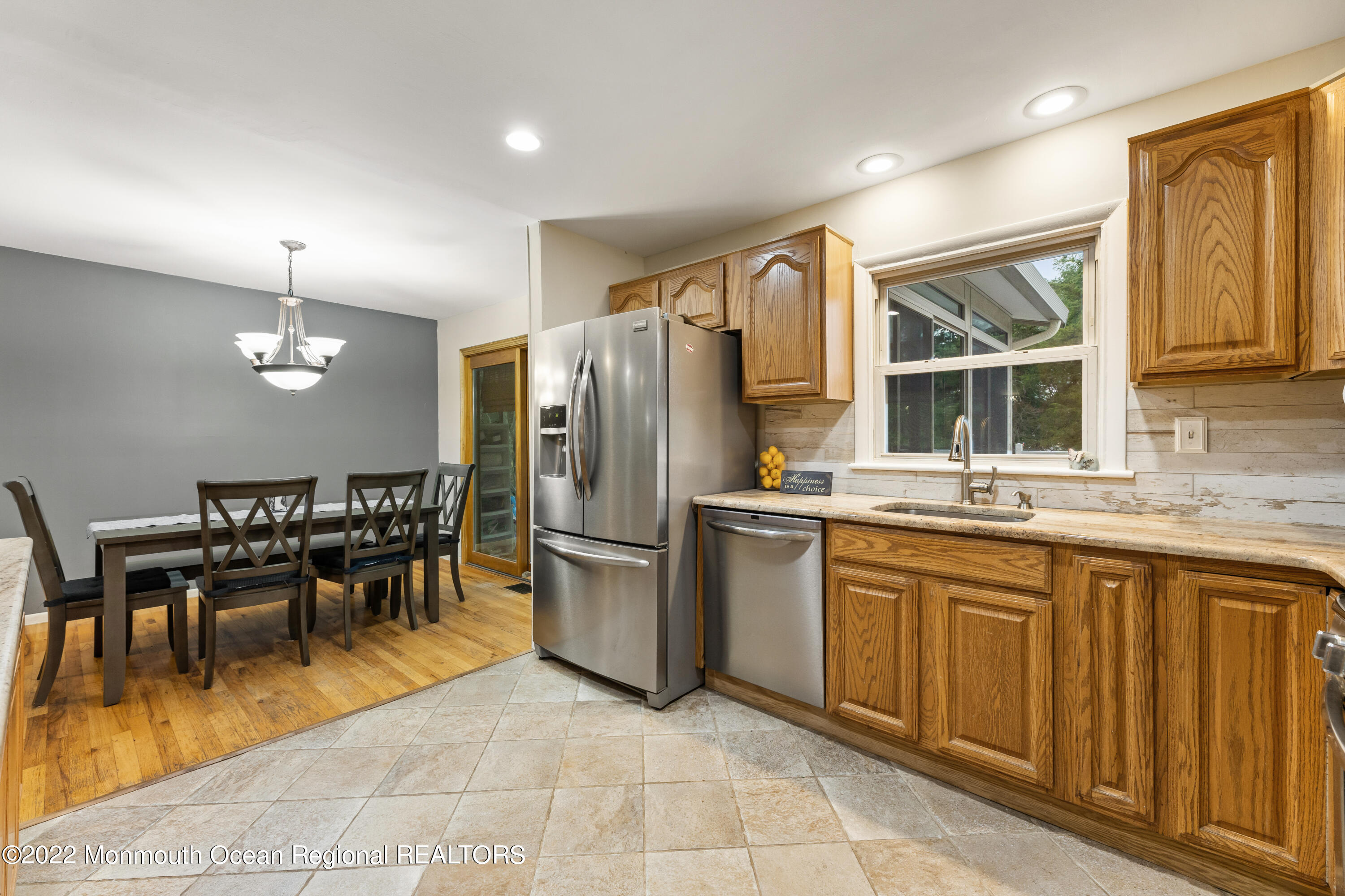 21 Holiday Road Manalapan, NJ 07726 - Photo 16 of 30 a kitchen with stainless steel appliances granite countertop a table chairs and a refrigerator