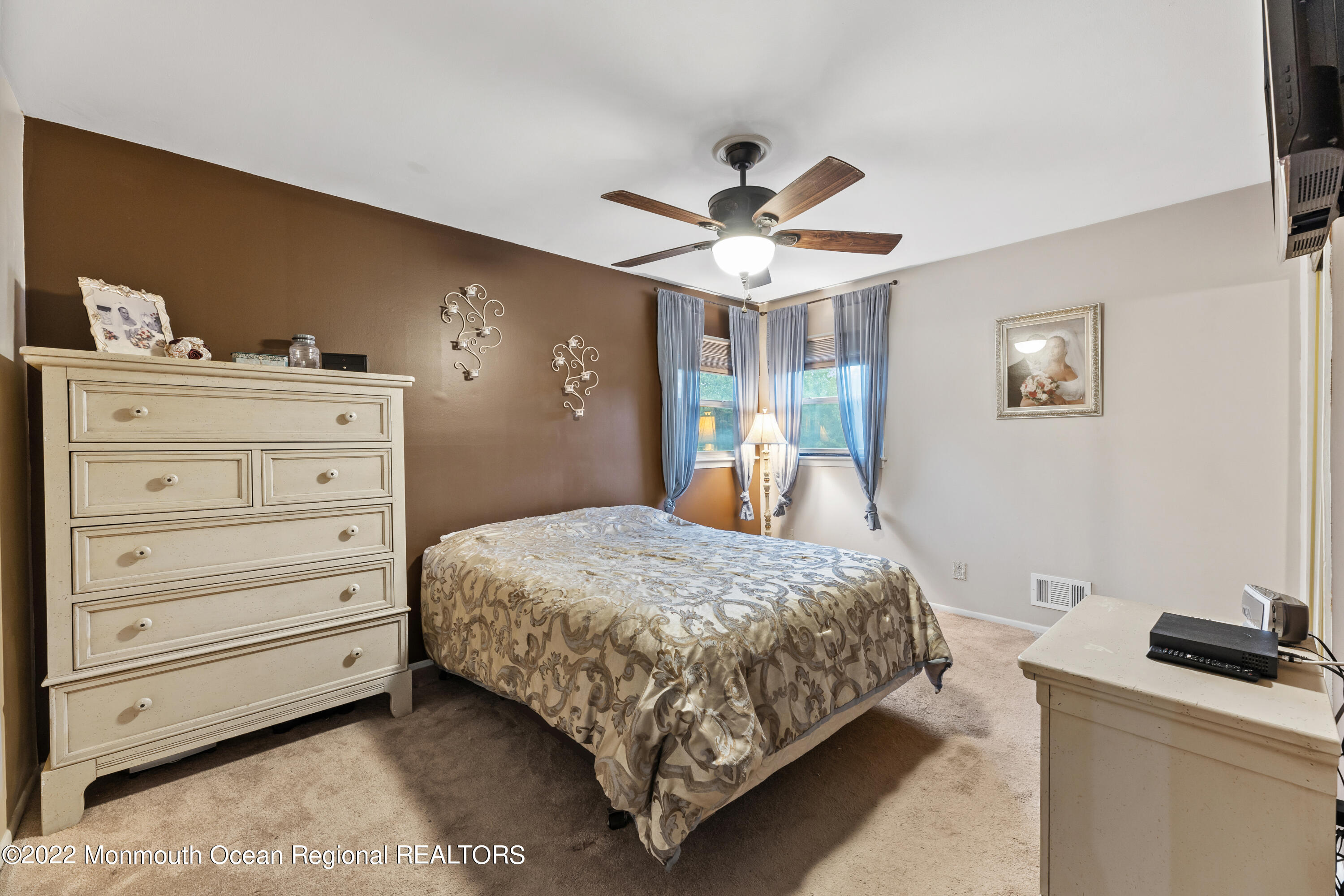 21 Holiday Road Manalapan, NJ 07726 - Photo 19 of 30 a bedroom with a bed and a chandelier