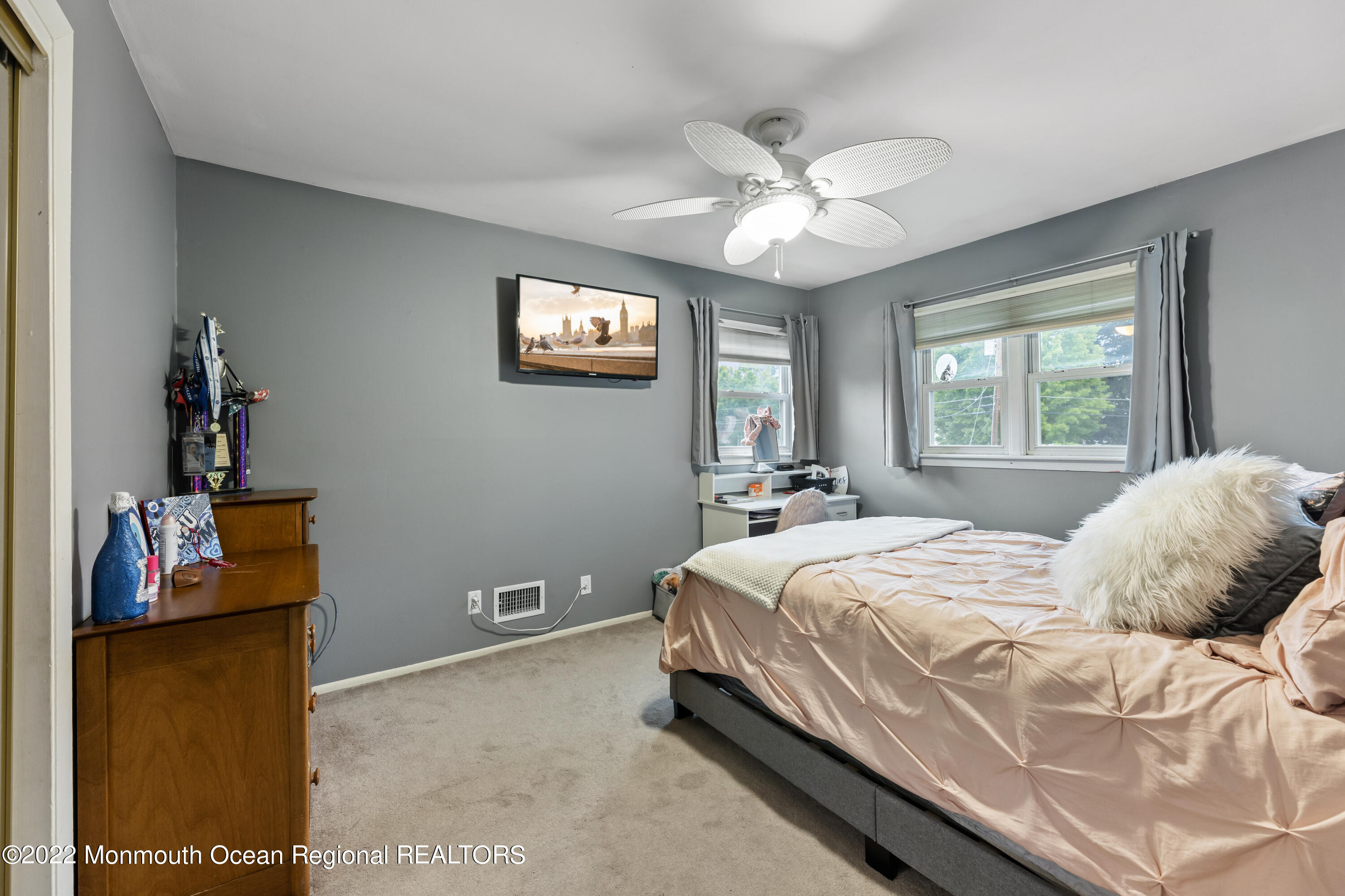 21 Holiday Road Manalapan, NJ 07726 - Photo 20 of 30 a bedroom with a bed and a chandelier