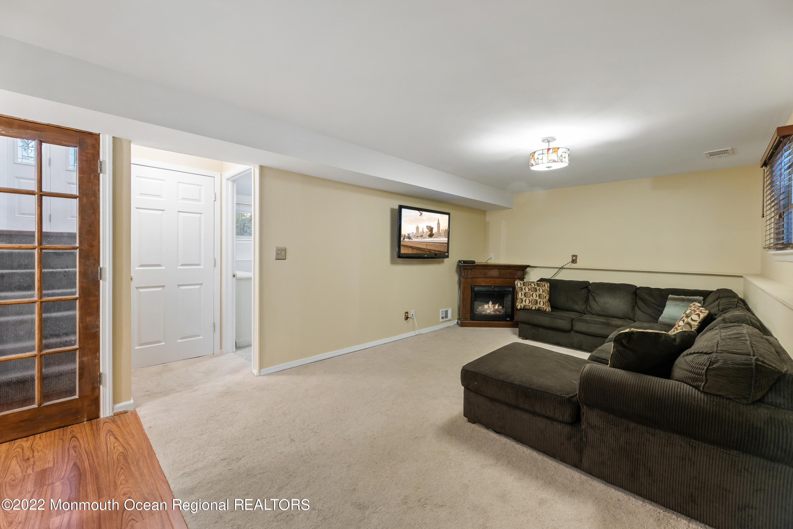 21 Holiday Road Manalapan, NJ 07726 - Photo 24 of 30 a living room with furniture and a flat screen tv
