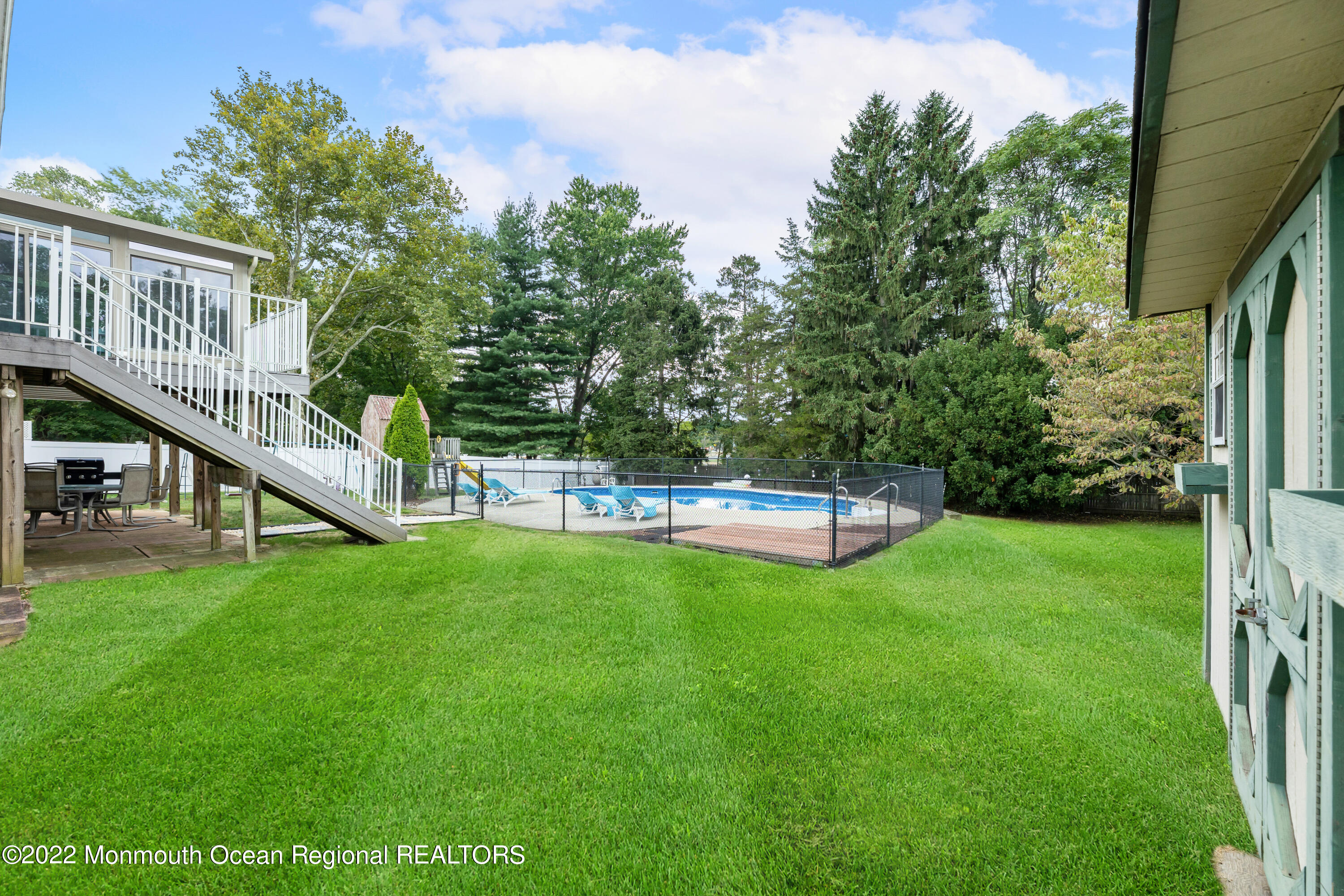 21 Holiday Road Manalapan, NJ 07726 - Photo 3 of 30 a view of a house with pool and a yard