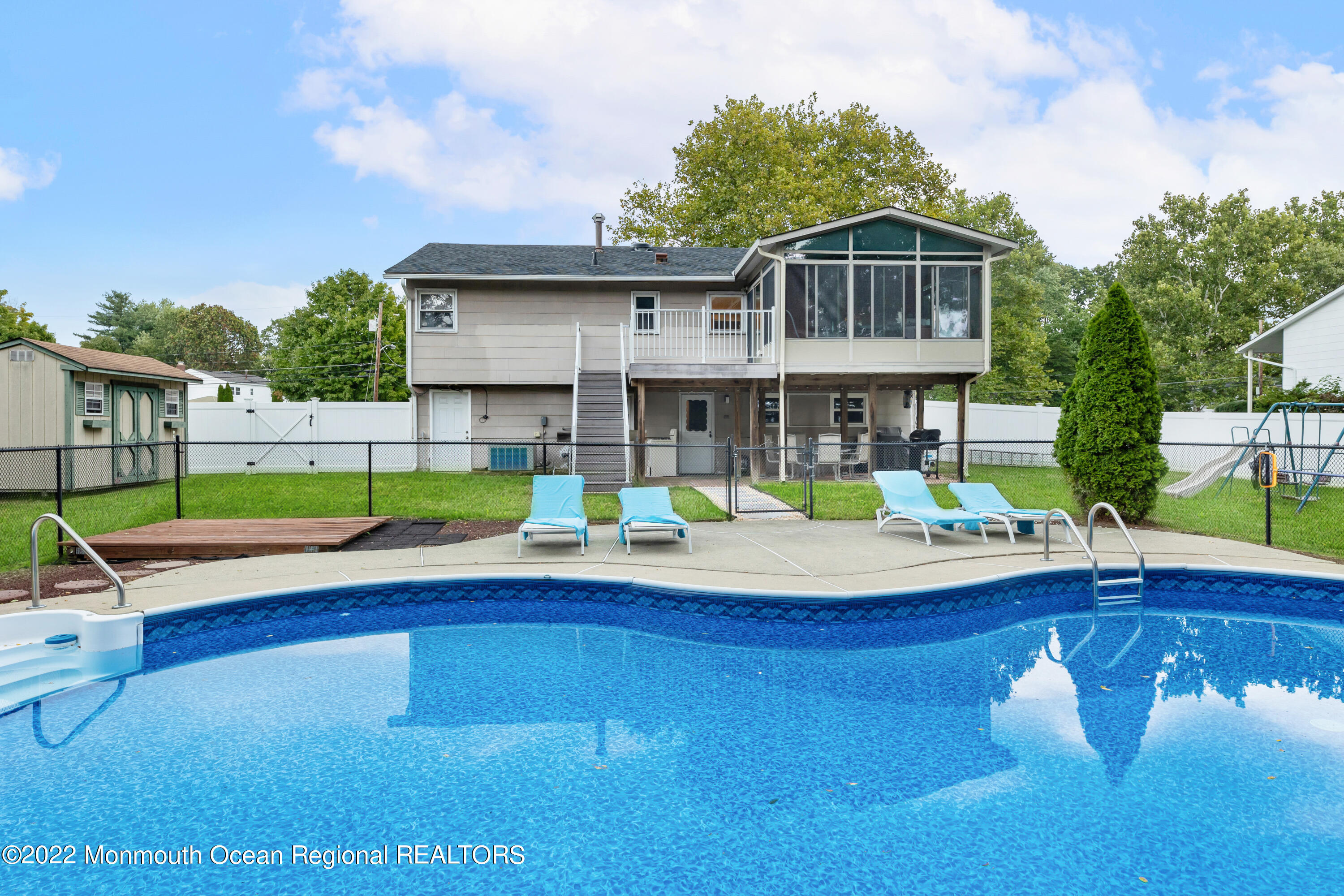 21 Holiday Road Manalapan, NJ 07726 - Photo 6 of 30 a view of a house with pool and chairs