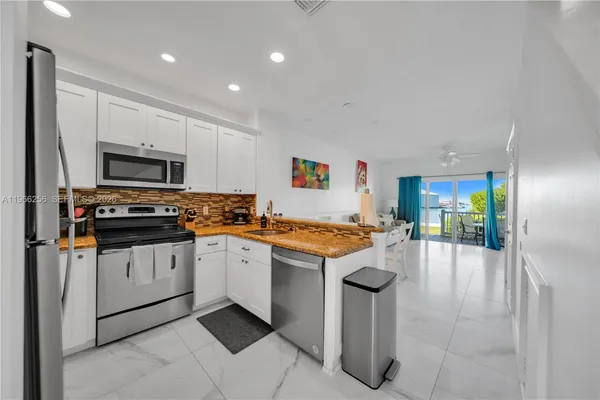 a kitchen with stainless steel appliances granite countertop a stove and a sink