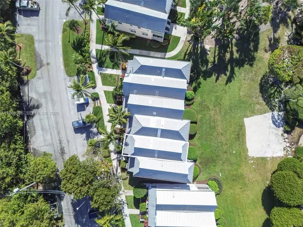 an aerial view of a house with a yard and potted plants